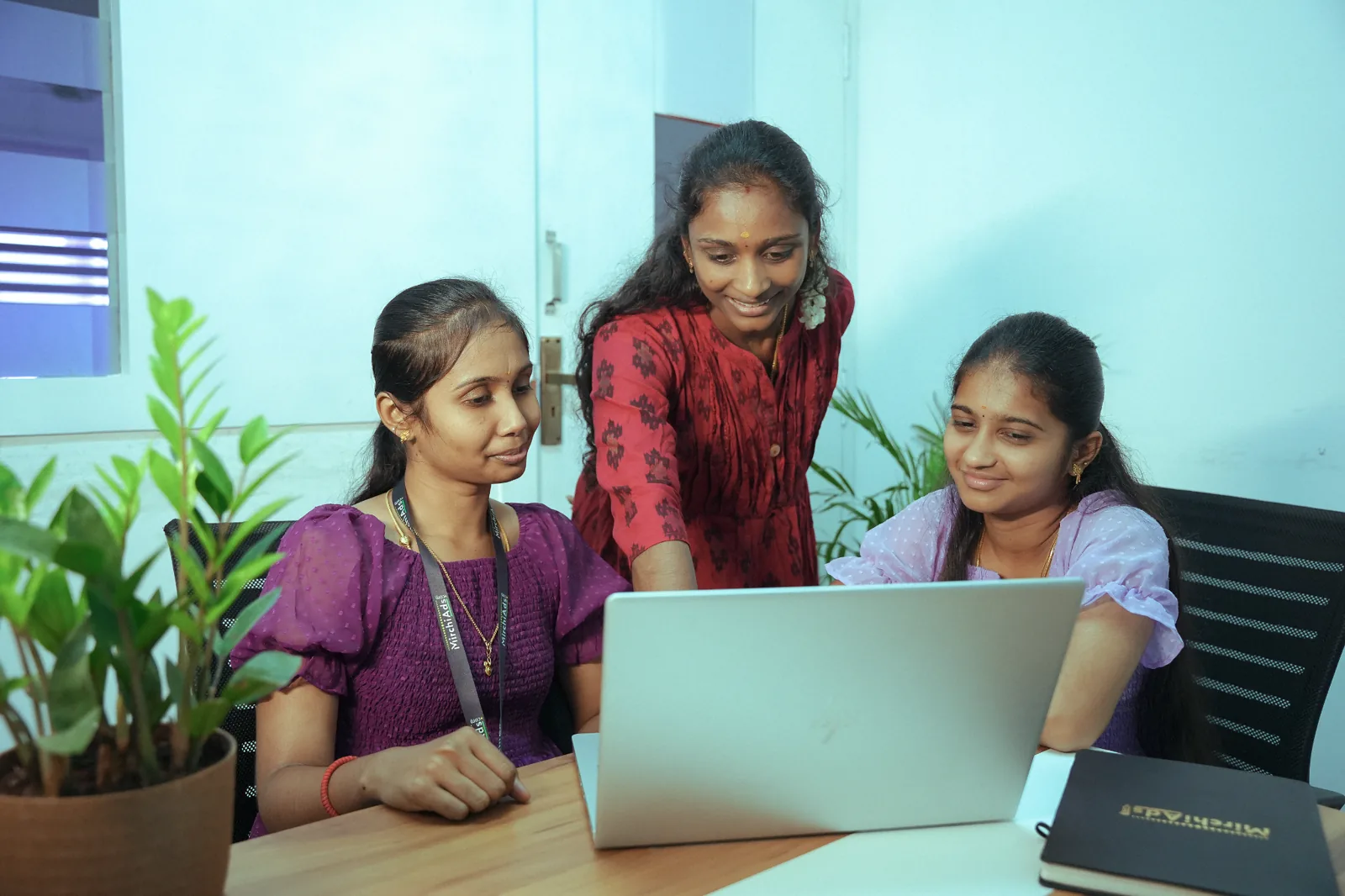 MirchiAds team collaborating at the office